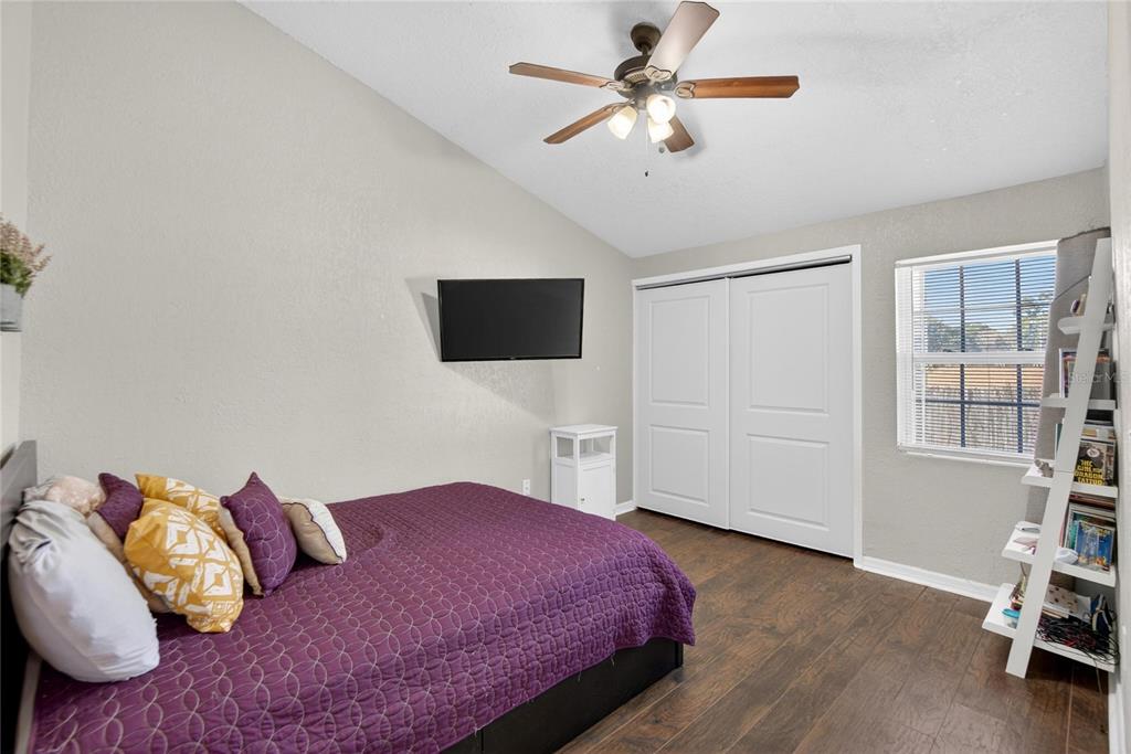 1009 Lenna Avenue Seffner, FL 33584 - Photo 17 of 68 a spacious bedroom with a bed a window and a flat screen tv