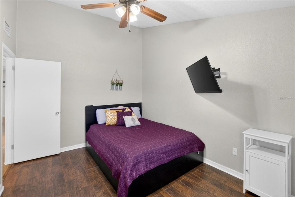 1009 Lenna Avenue Seffner, FL 33584 - Photo 18 of 68 a bedroom with a bed and a flat screen tv