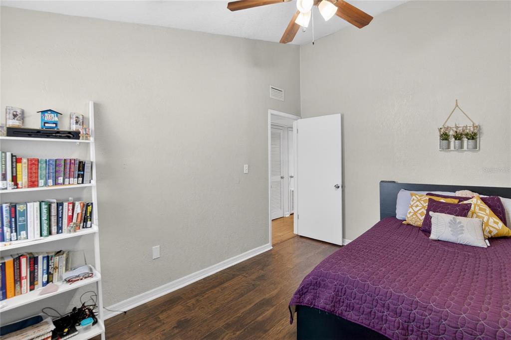 1009 Lenna Avenue Seffner, FL 33584 - Photo 19 of 68 a bedroom with a bed and a book shelf