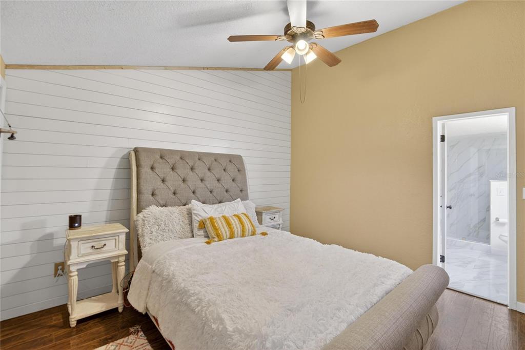 1009 Lenna Avenue Seffner, FL 33584 - Photo 26 of 68 a bedroom with a bed and wooden floor