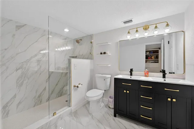 a view of walk in closet with clothes