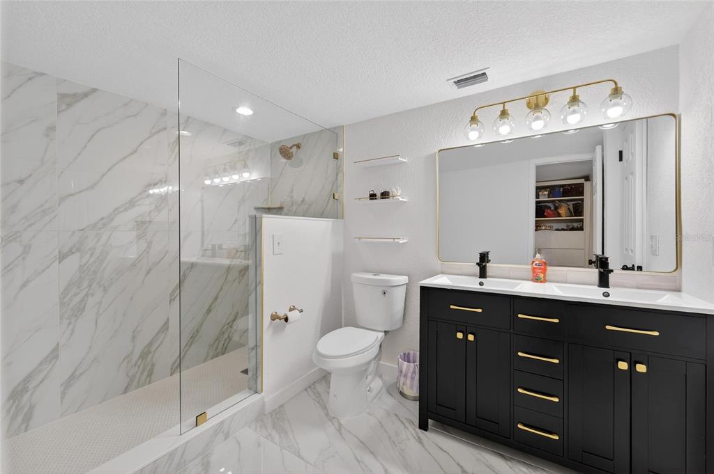 1009 Lenna Avenue Seffner, FL 33584 - Photo 33 of 68 a spacious bathroom with a double vanity sink mirror and toilet