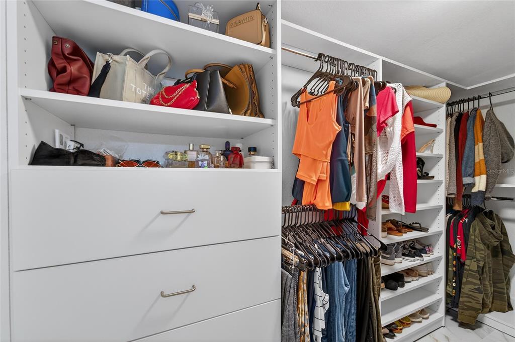 1009 Lenna Avenue Seffner, FL 33584 - Photo 35 of 68 a view of walk in closet with clothes and shoes