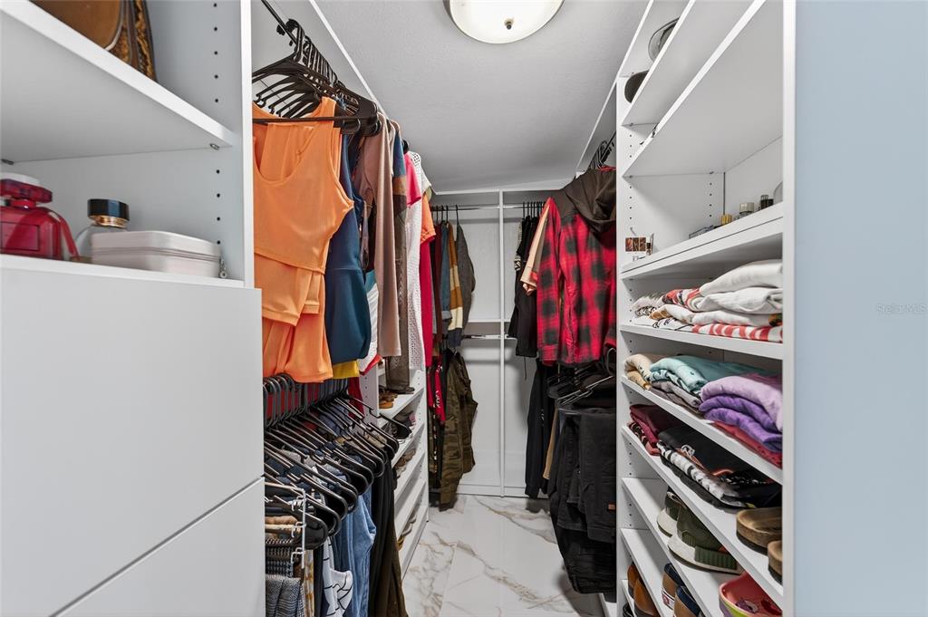 1009 Lenna Avenue Seffner, FL 33584 - Photo 36 of 68 a view of walk in closet with clothes and shoes