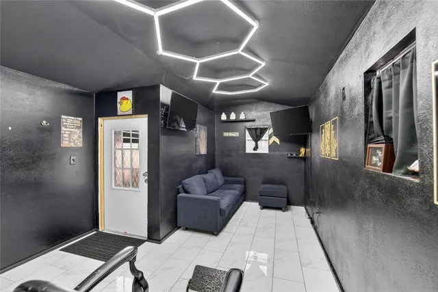 a view of a two chairs in the back yard of the house