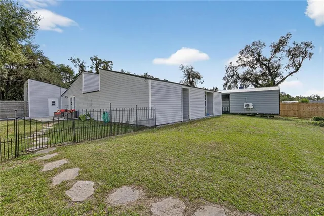 a view of a house with a garage and yard