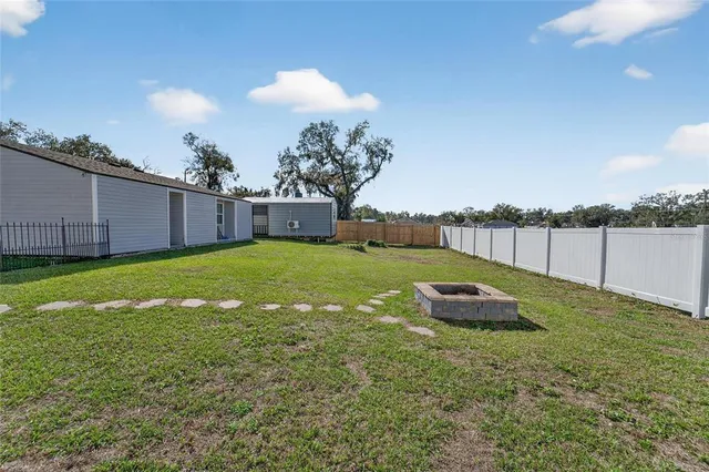 an aerial view of a house with a yard basket ball court and outdoor seating