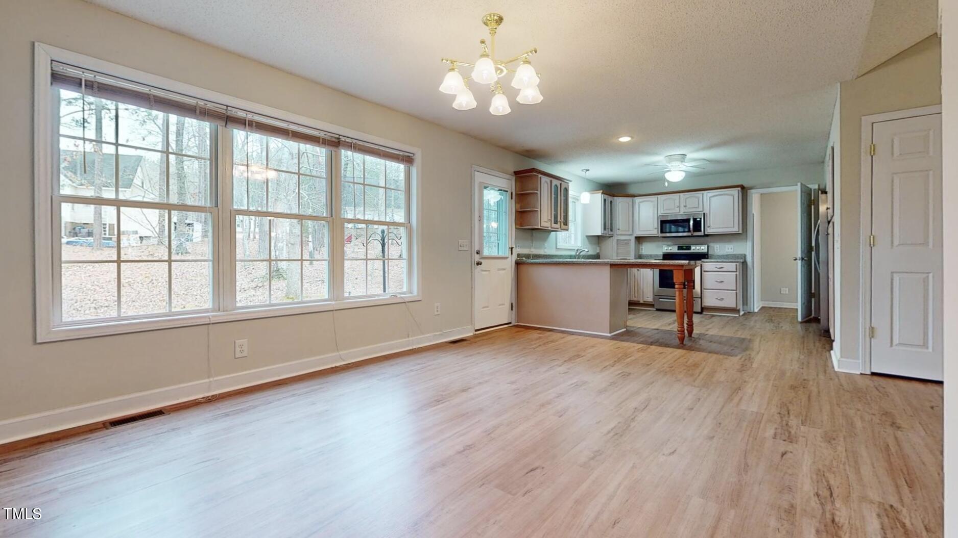 131 Brookfield Circle Sanford, NC 27330 - Photo 11 of 46 a view of a kitchen with a stove cabinets and wooden floor