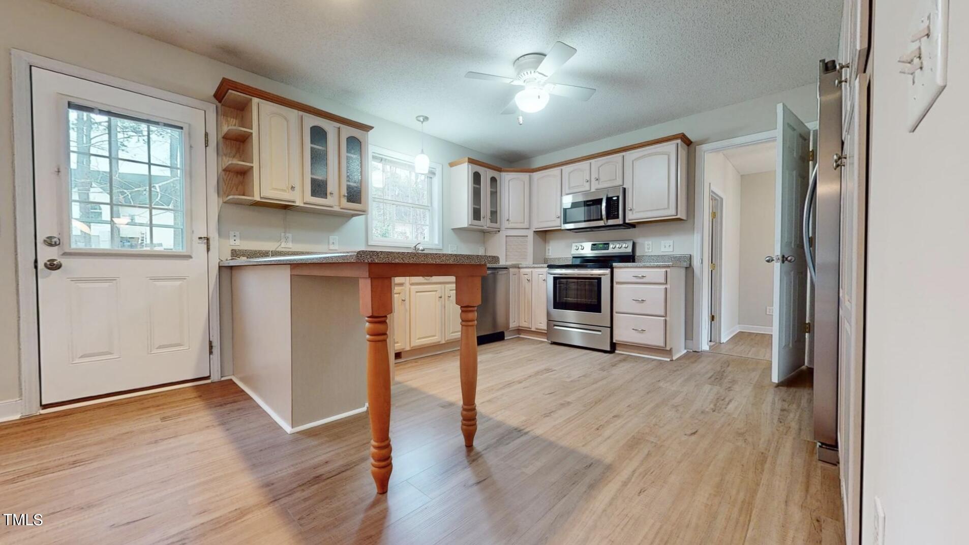 131 Brookfield Circle Sanford, NC 27330 - Photo 12 of 46 a view of kitchen with stainless steel appliances granite countertop a stove top oven a sink dishwasher and a refrigerator with wooden floor