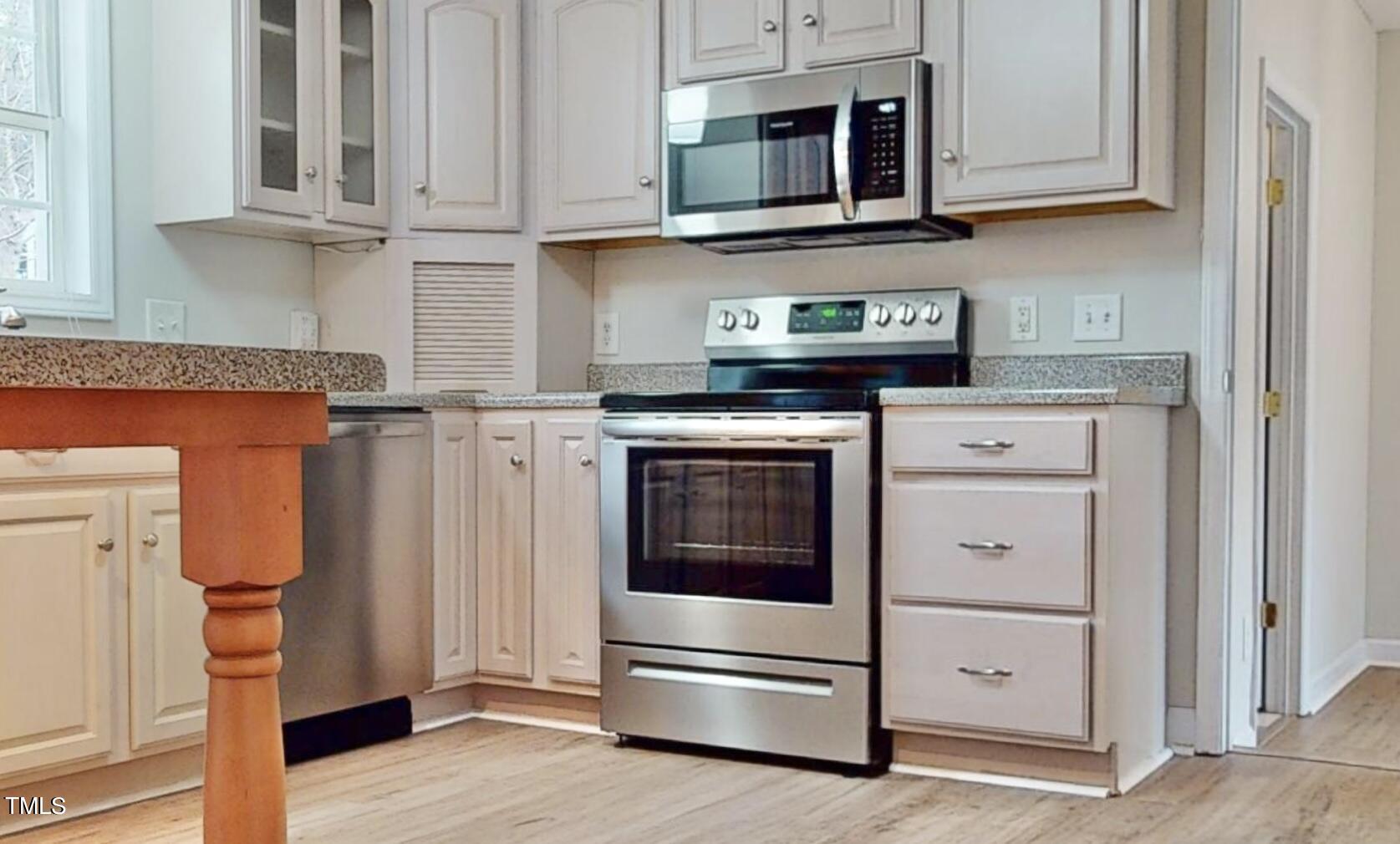131 Brookfield Circle Sanford, NC 27330 - Photo 13 of 46 a kitchen with stainless steel appliances granite countertop a stove microwave and cabinets