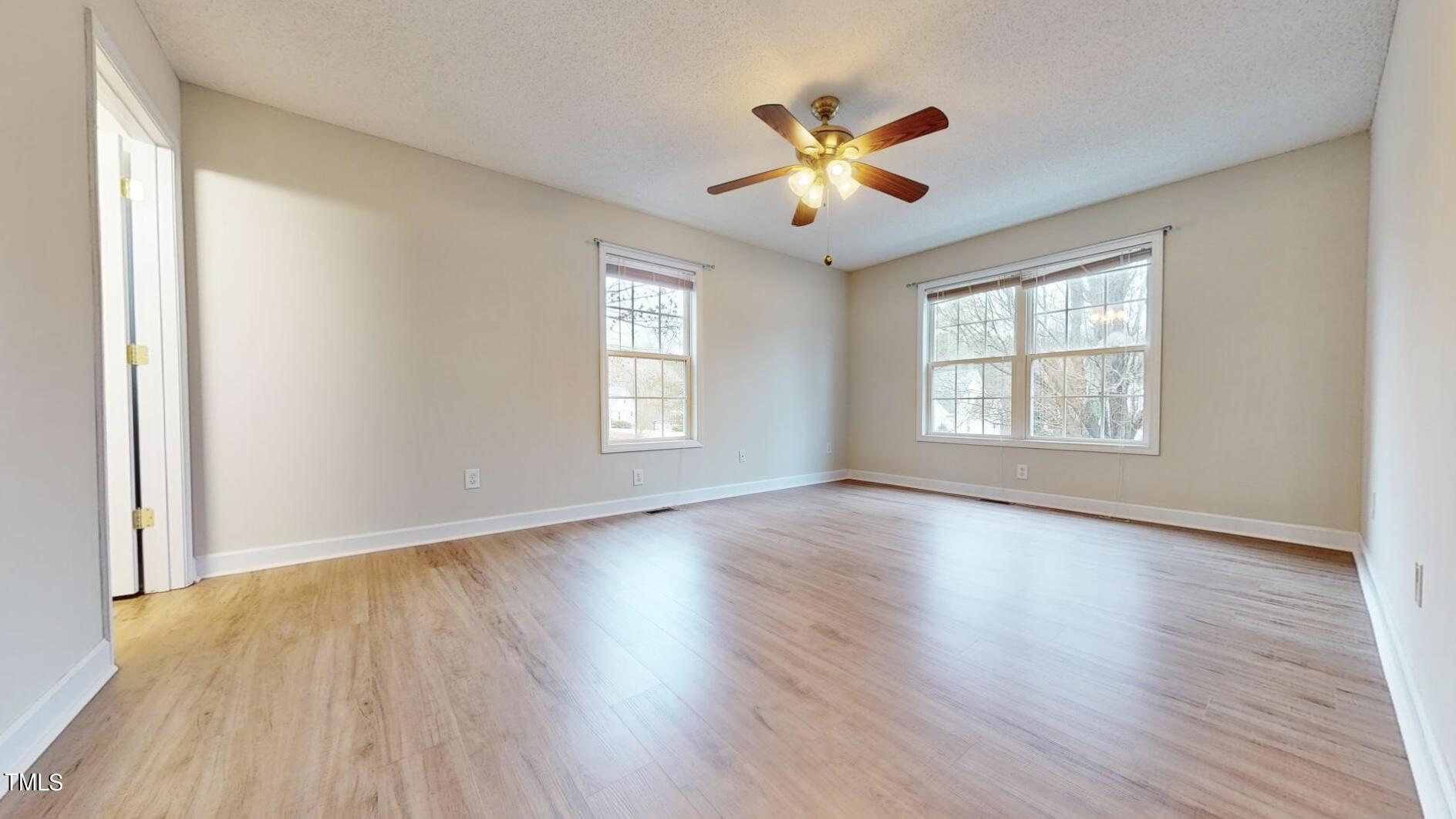 131 Brookfield Circle Sanford, NC 27330 - Photo 17 of 46 a view of an empty room with wooden floor and a window