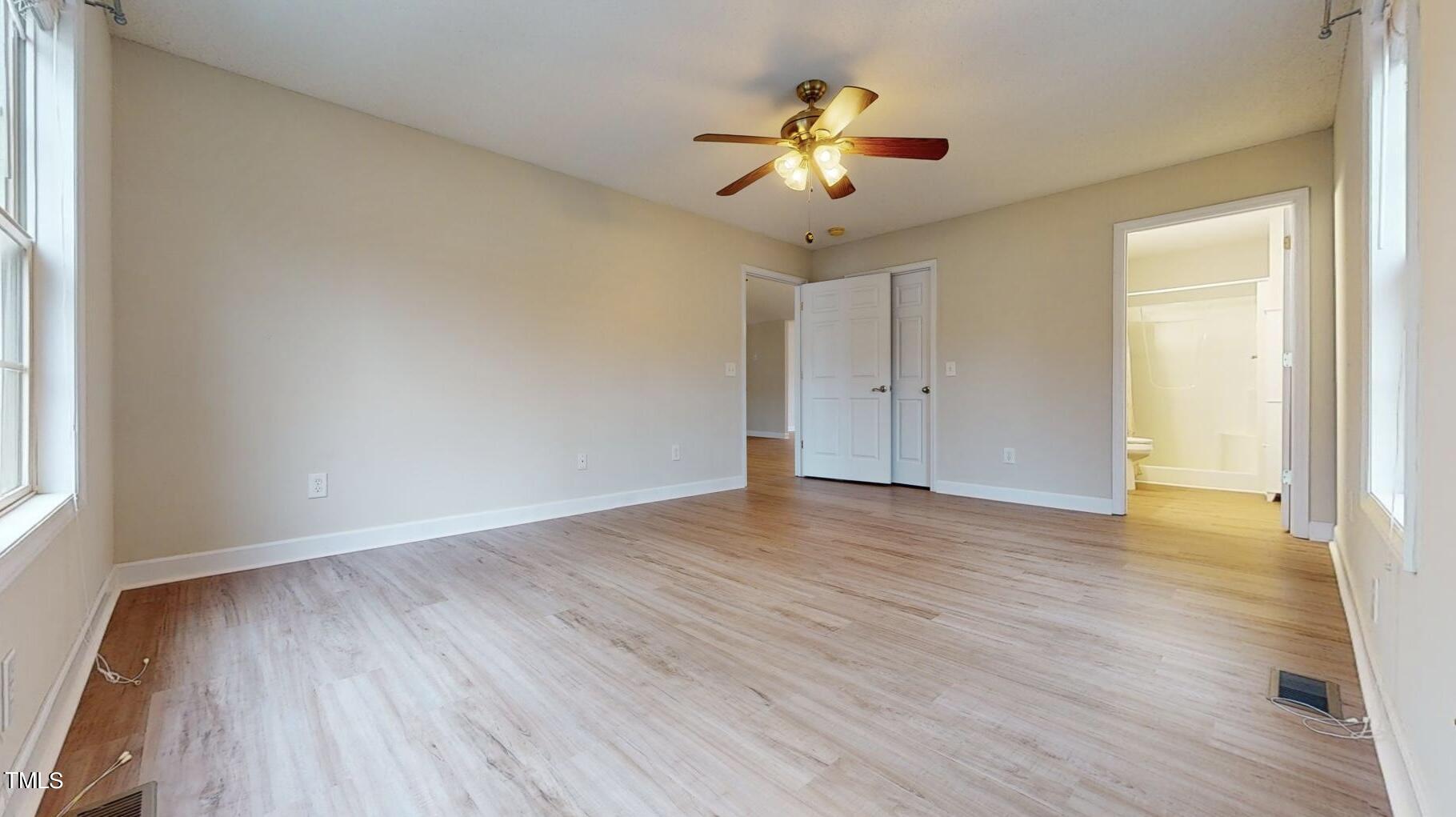 131 Brookfield Circle Sanford, NC 27330 - Photo 19 of 46 an empty room with wooden floor and chandelier