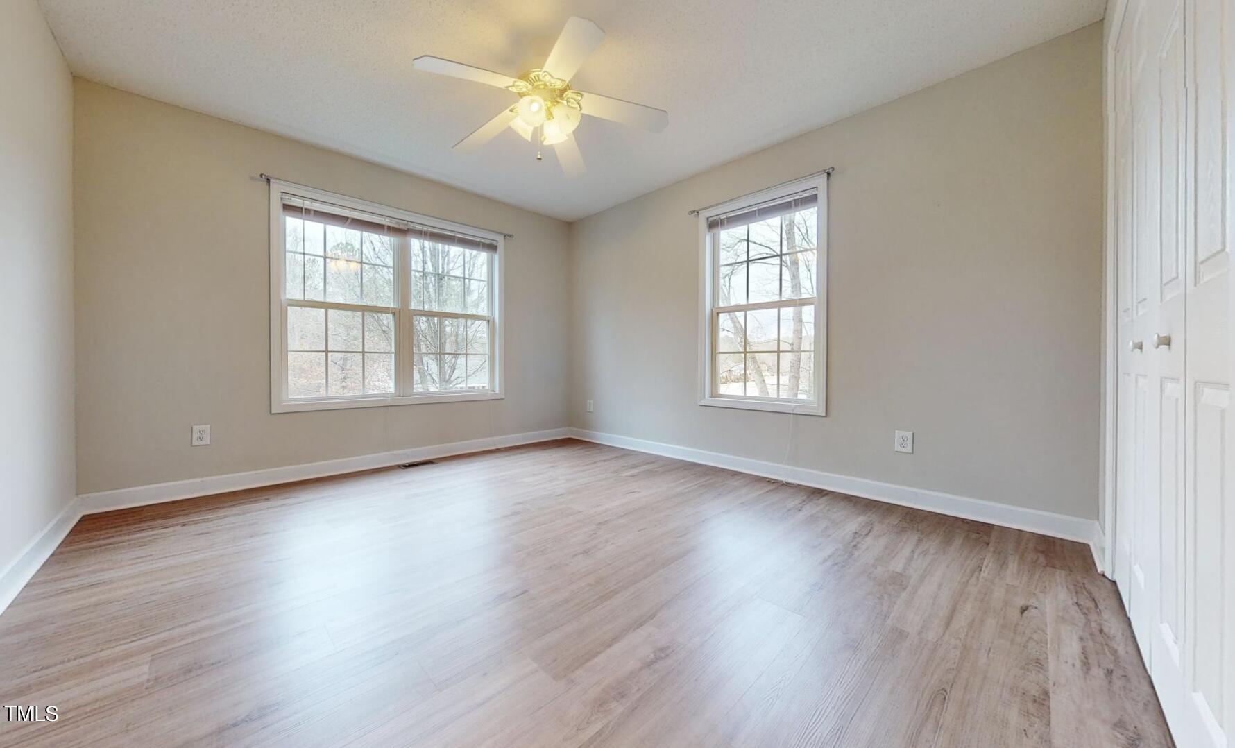 131 Brookfield Circle Sanford, NC 27330 - Photo 23 of 46 an empty room with wooden floor and windows