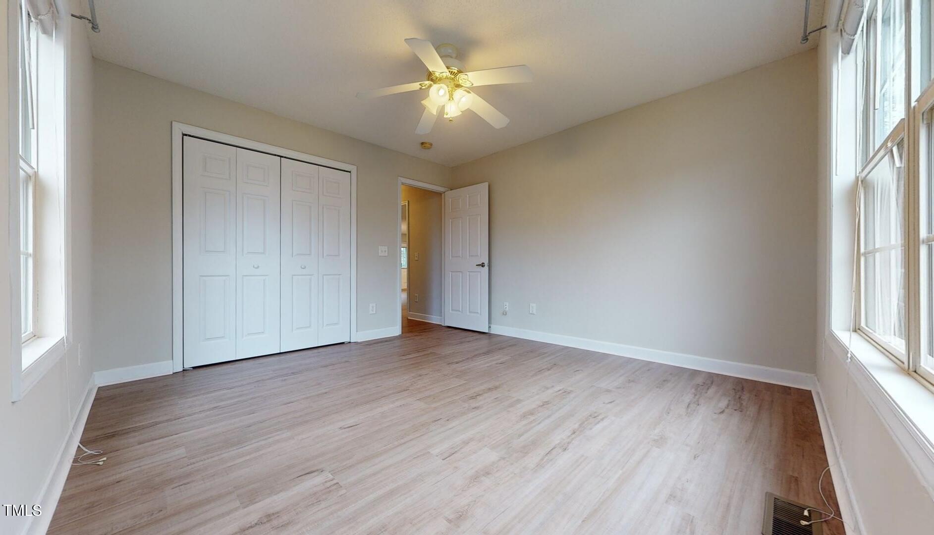 131 Brookfield Circle Sanford, NC 27330 - Photo 24 of 46 an empty room with wooden floor and windows