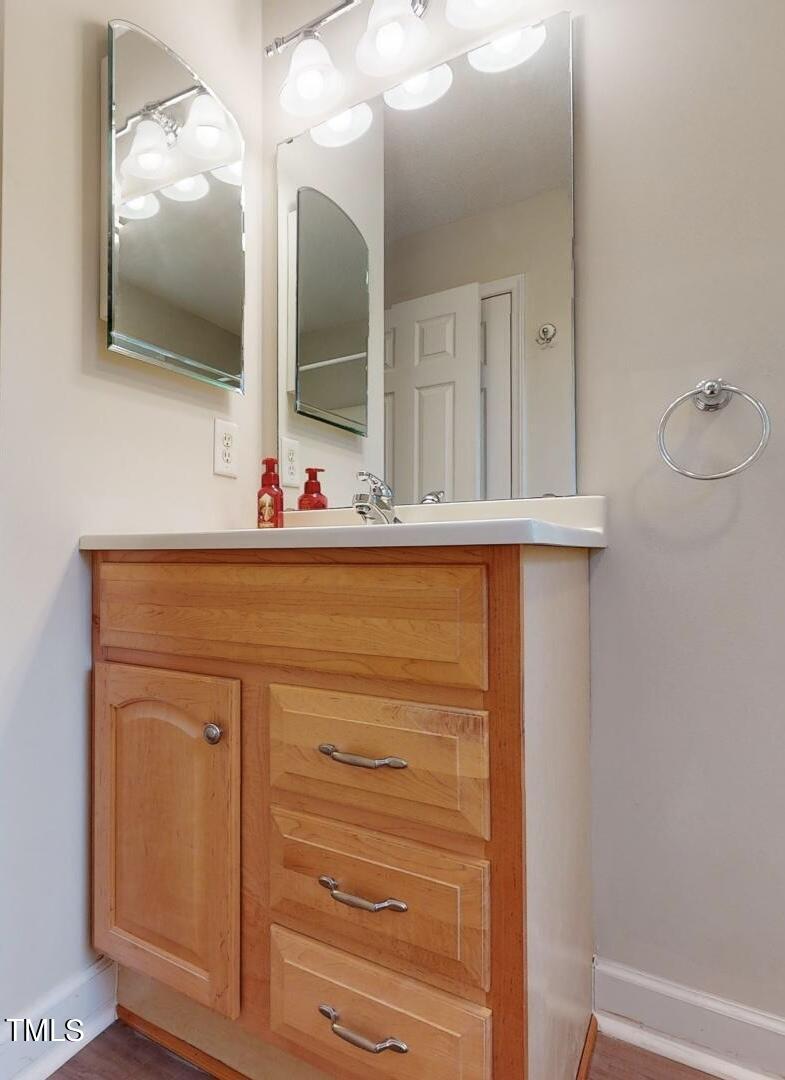 131 Brookfield Circle Sanford, NC 27330 - Photo 28 of 46 a bathroom with a sink and a mirror