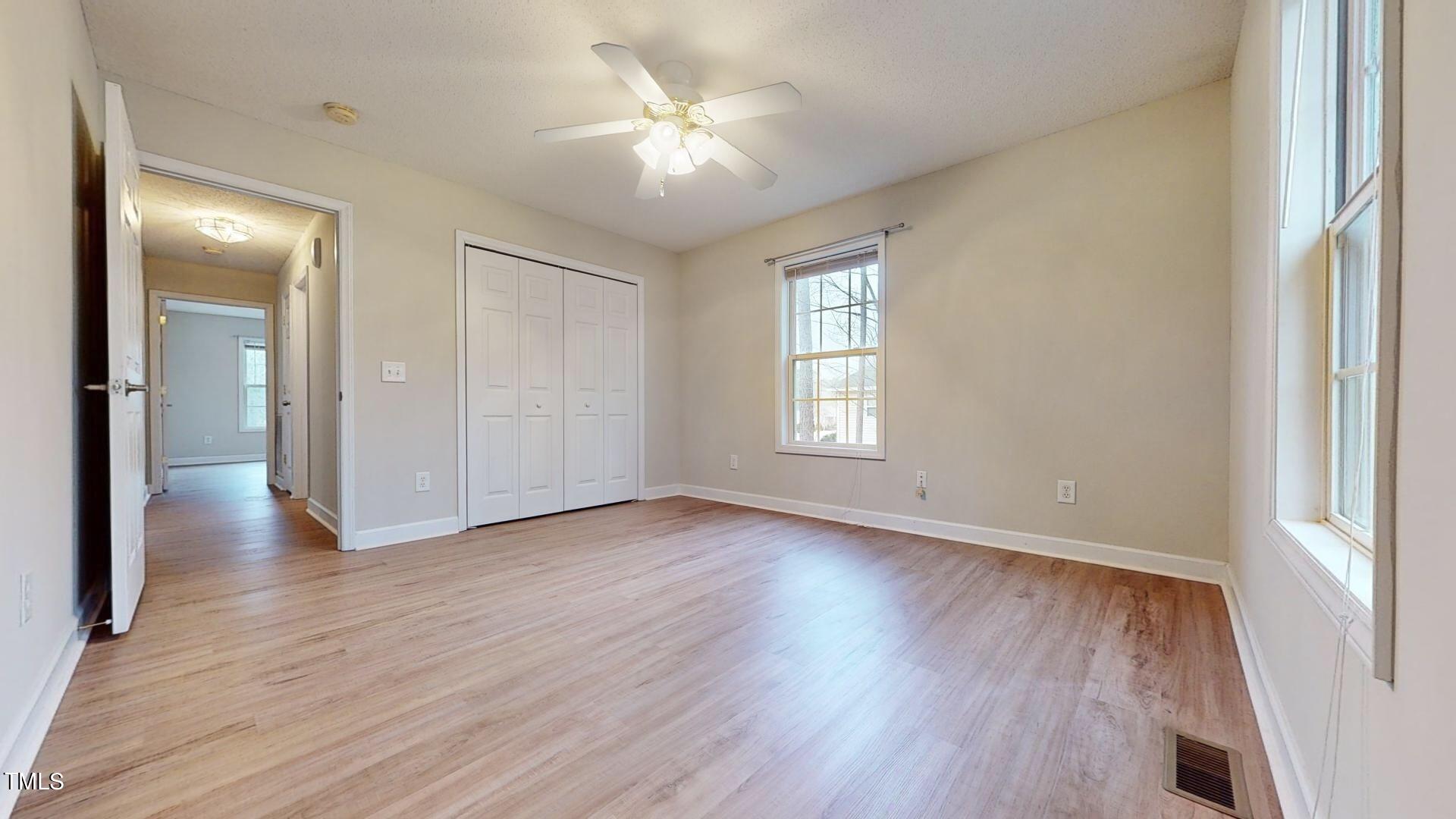 131 Brookfield Circle Sanford, NC 27330 - Photo 32 of 46 an empty room with wooden floor and windows