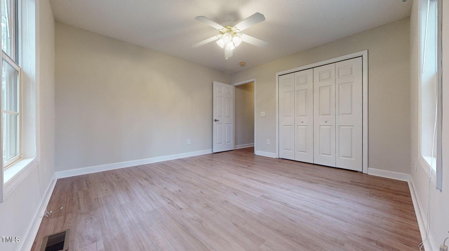 131 Brookfield Circle Sanford, NC 27330 - Photo 33 of 46 an empty room with wooden floor and windows