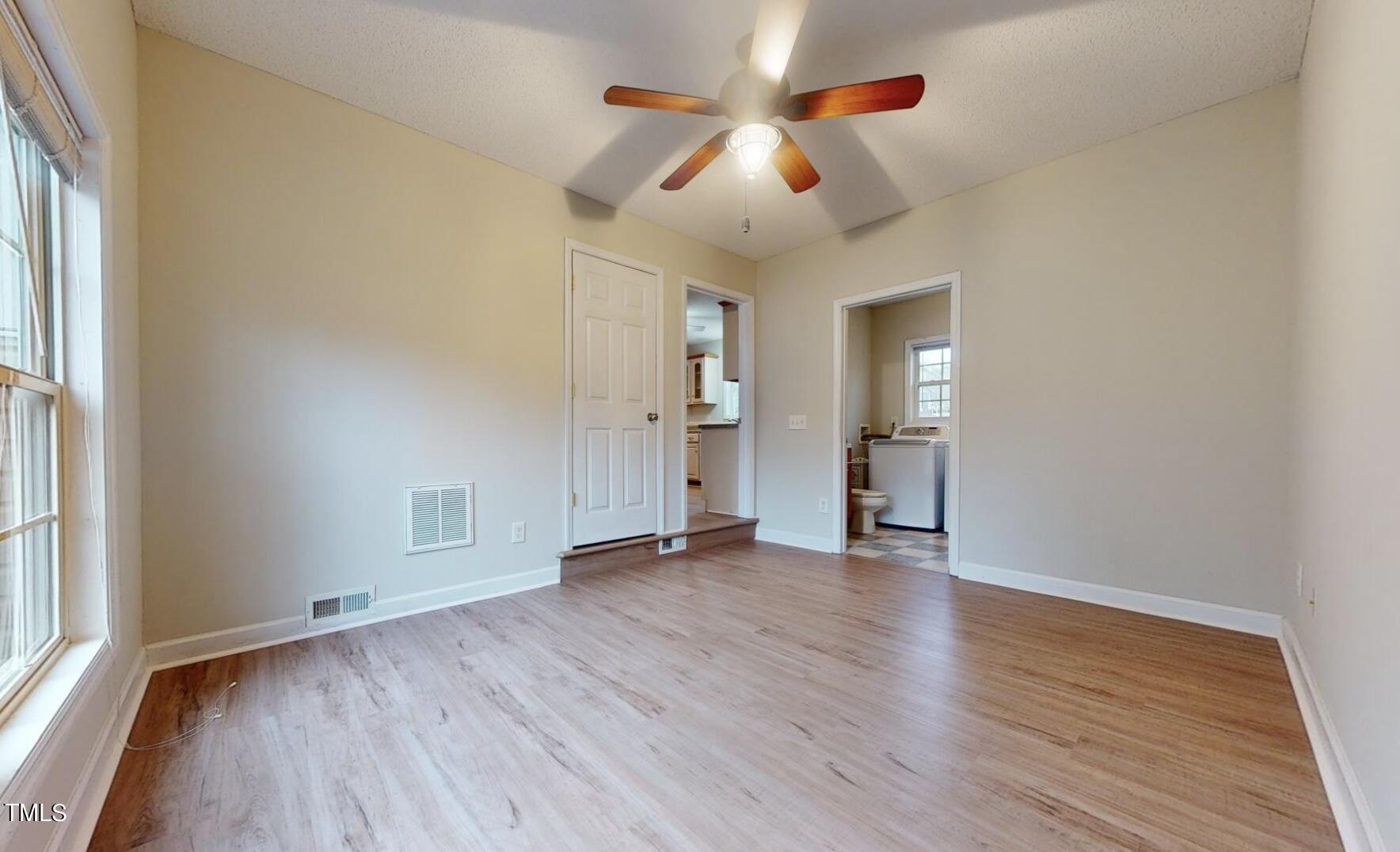 131 Brookfield Circle Sanford, NC 27330 - Photo 35 of 46 an empty room with wooden floor and windows