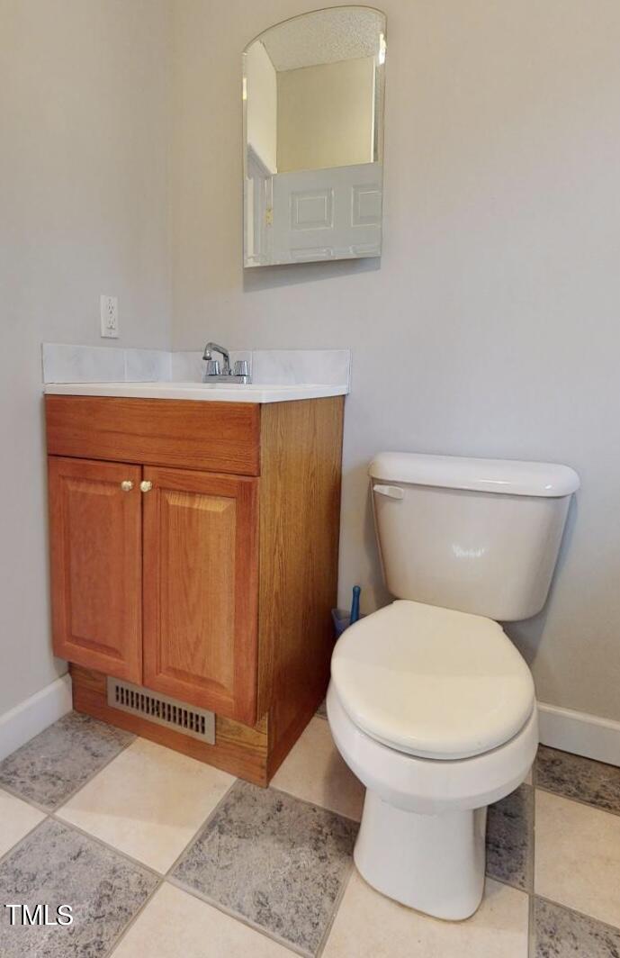 131 Brookfield Circle Sanford, NC 27330 - Photo 37 of 46 a bathroom with a toilet a sink and mirror