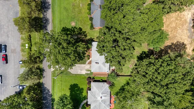 an aerial view of a house with a yard and garden
