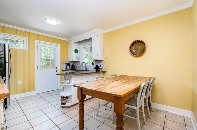 a view of a dining room with furniture and window
