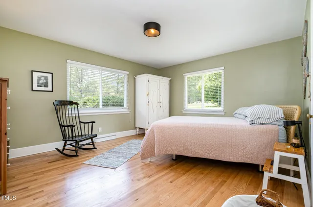 a bedroom with a bed windows and a window