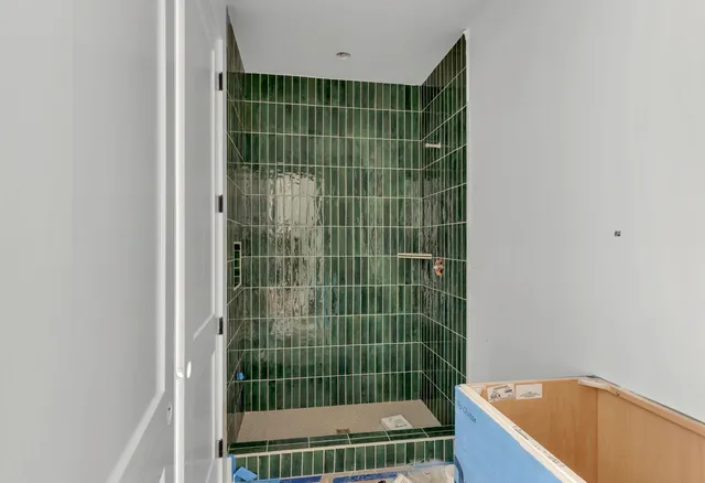 a view of bathroom with shower and a bathtub