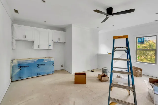 a living room with a baby crib furniture and a window