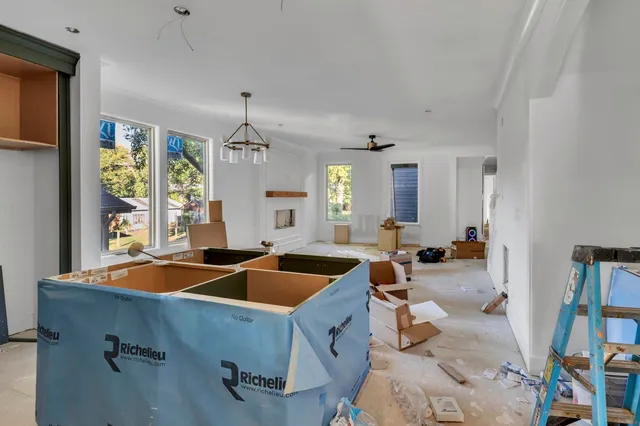a kitchen with a sink stove and living room