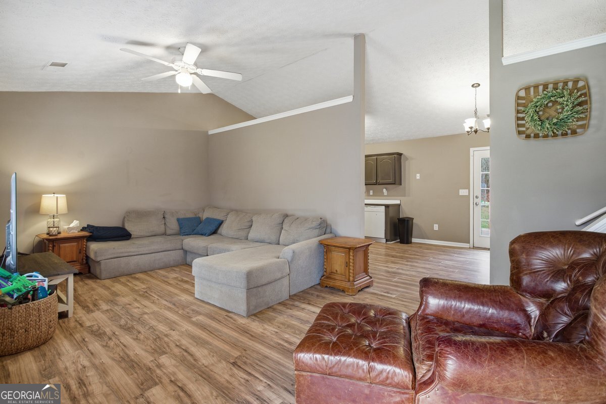 170 Hunters Trace Covington, GA 30014 - Photo 11 of 29 a living room with furniture and a chandelier
