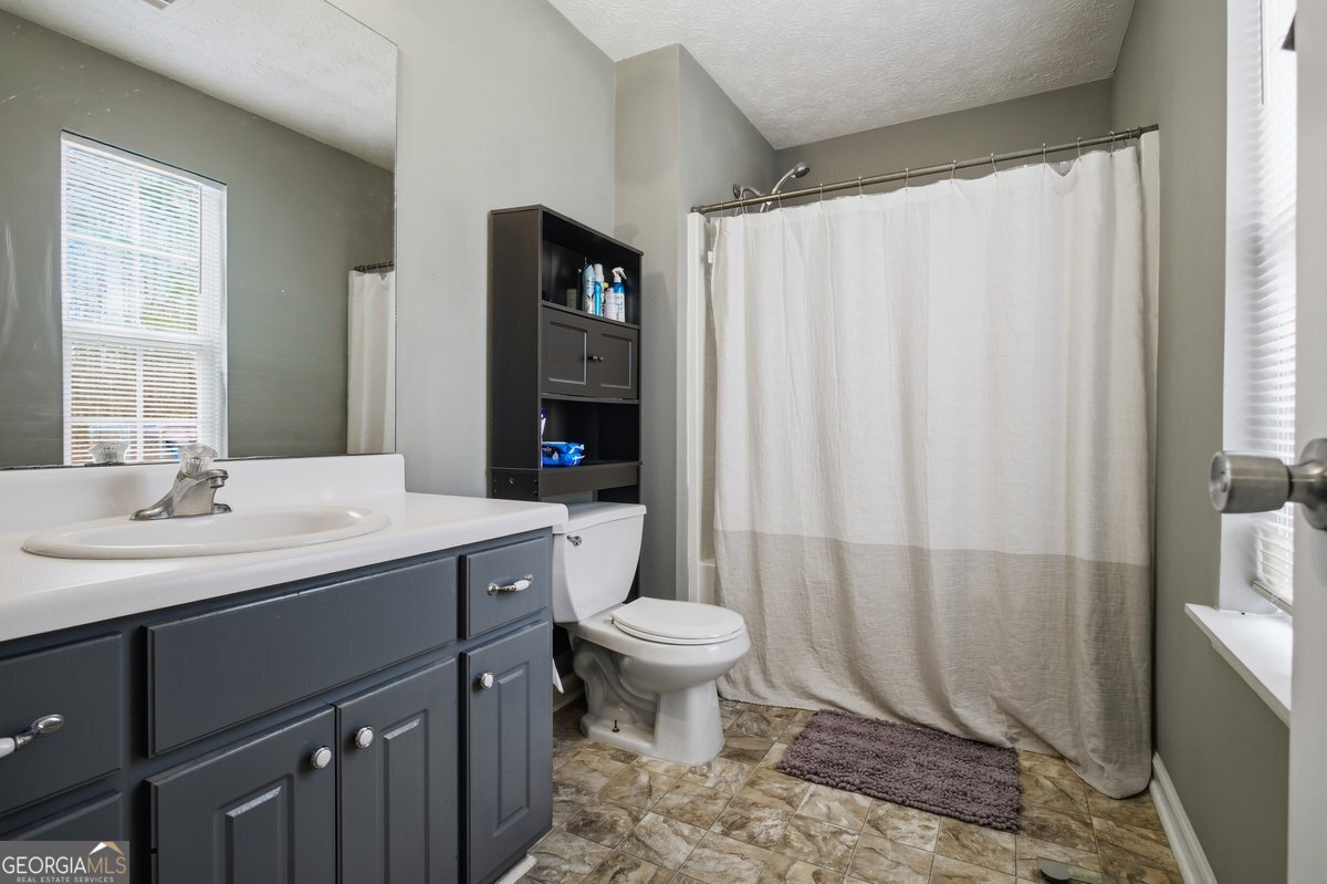 170 Hunters Trace Covington, GA 30014 - Photo 19 of 29 a bathroom with a sink toilet and shower