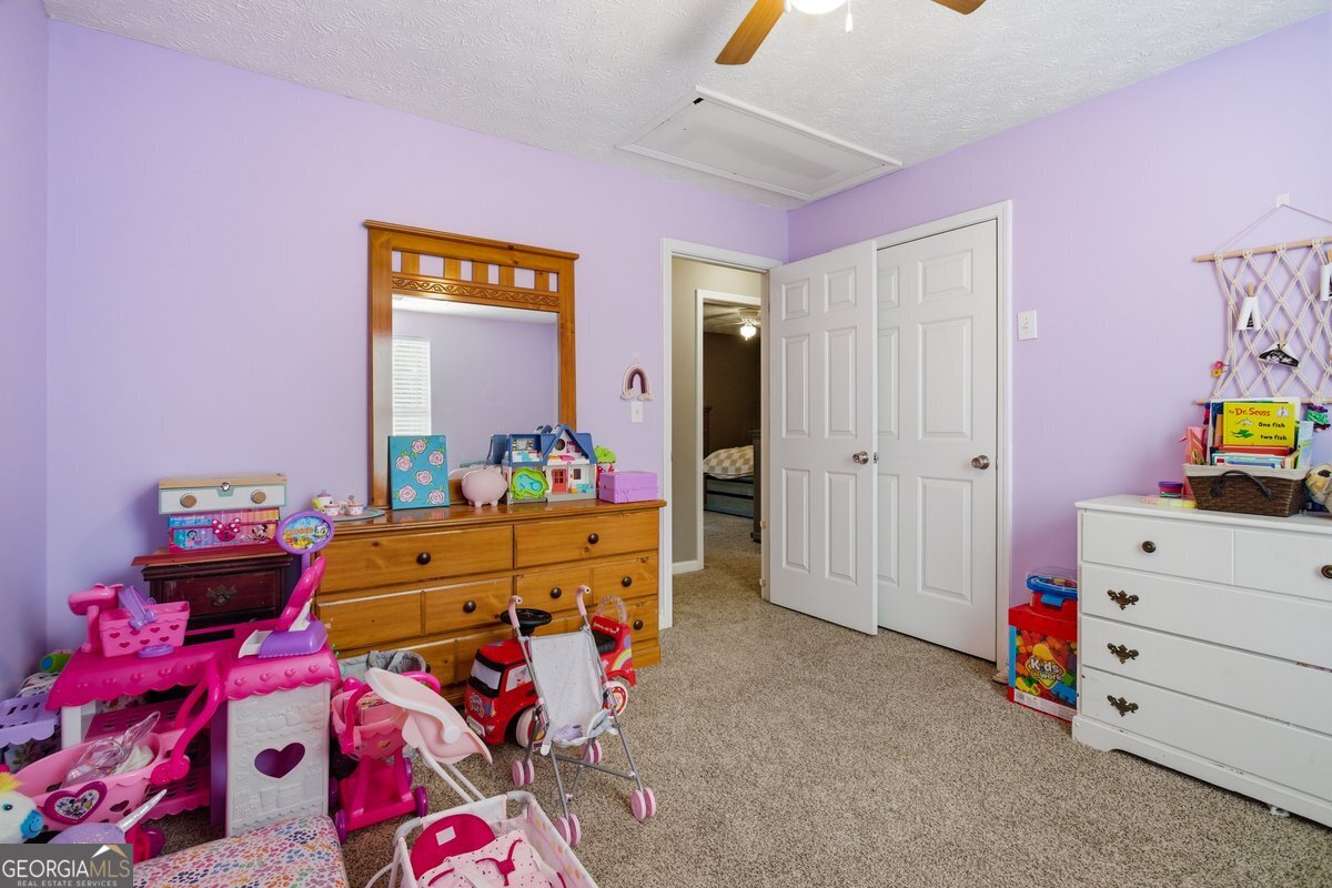 170 Hunters Trace Covington, GA 30014 - Photo 24 of 29 a bed room with a bed and a mirror