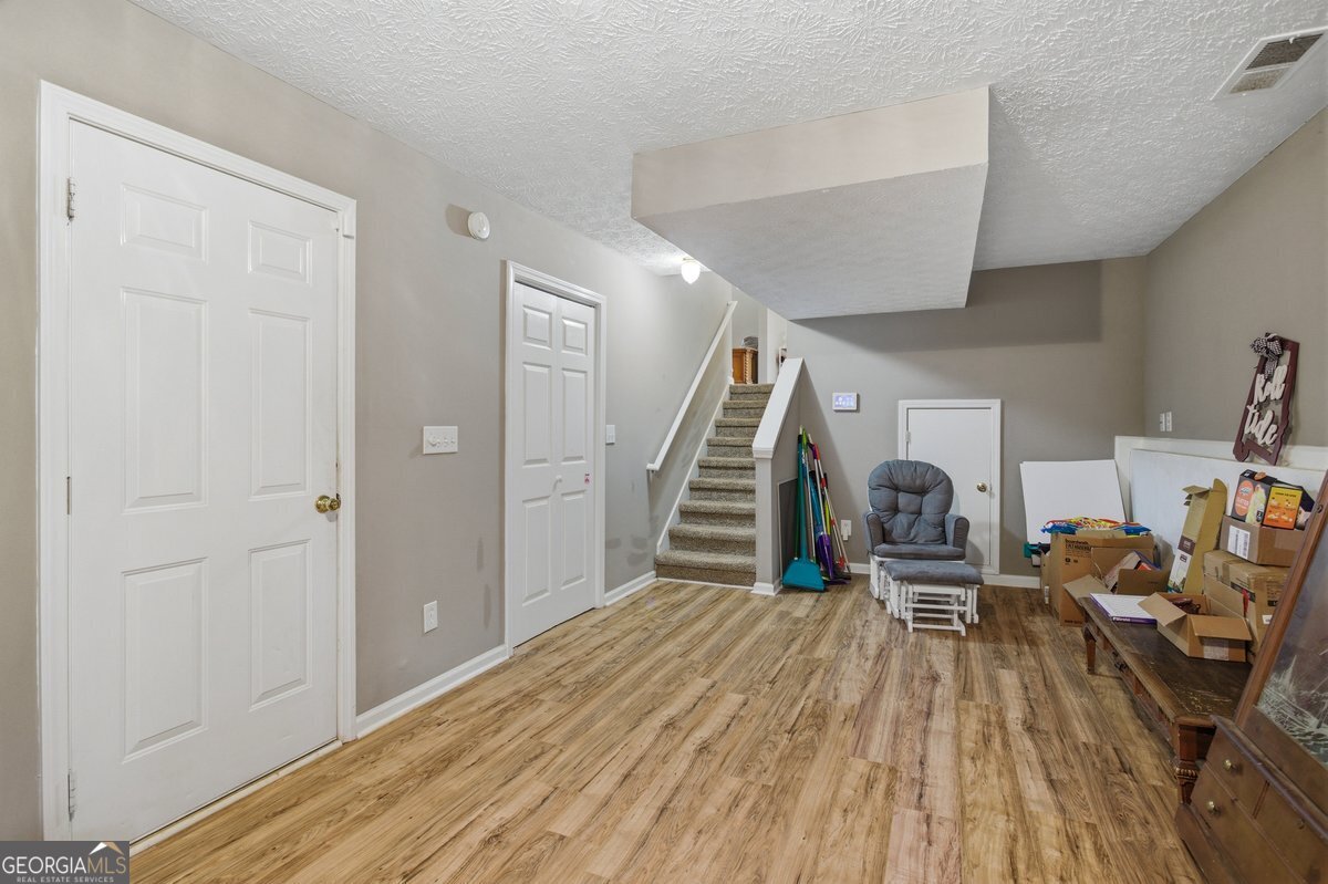 170 Hunters Trace Covington, GA 30014 - Photo 26 of 29 a view of empty room with wooden floor