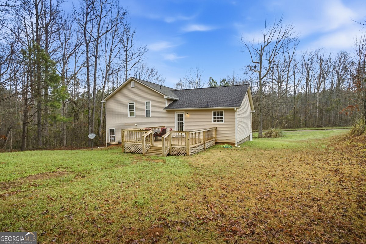 170 Hunters Trace Covington, GA 30014 - Photo 5 of 29 a white house that has a tree in front of it
