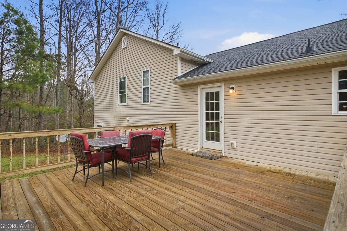 170 Hunters Trace Covington, GA 30014 - Photo 7 of 29 a backyard of a house with wooden floor chairs and table