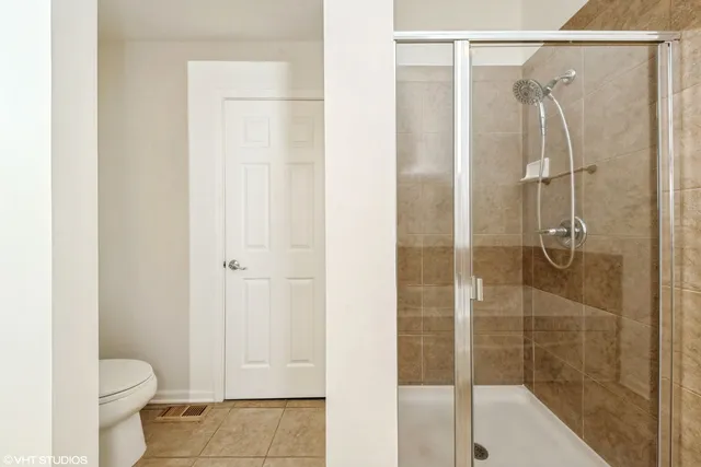 a bathroom with a shower and a toilet