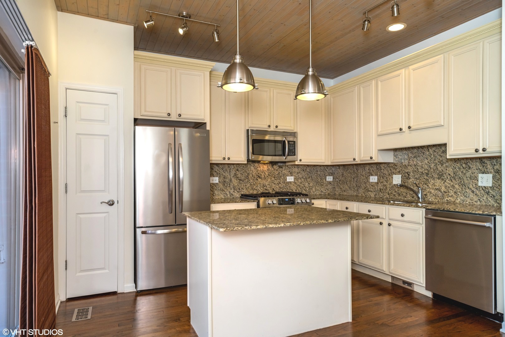 2517 South Calumet Avenue, Unit 31A Chicago, IL 60616 - Photo 5 of 17 a kitchen with stainless steel appliances granite countertop a refrigerator a sink and white cabinets