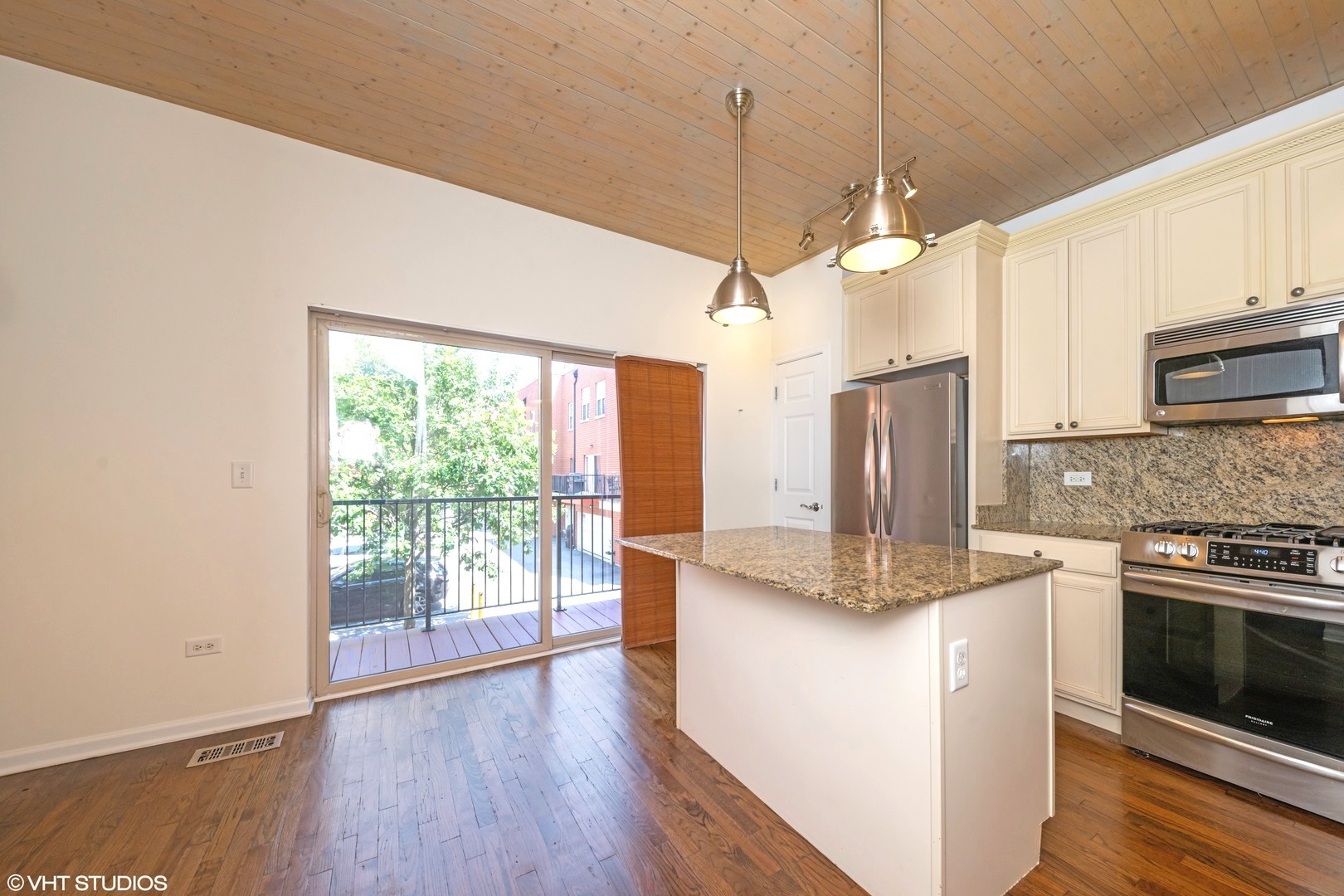 2517 South Calumet Avenue, Unit 31A Chicago, IL 60616 - Photo 6 of 17 a kitchen with stainless steel appliances granite countertop a stove a refrigerator a sink and white cabinets with wooden floor