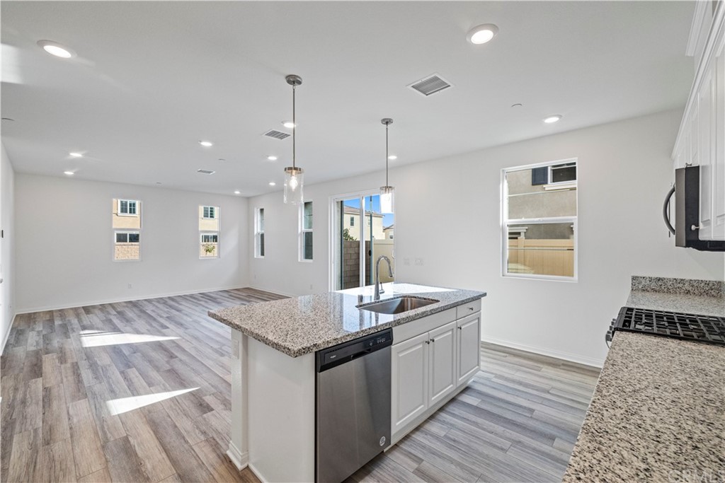 1752 Apricot Tree Place Upland, CA 91784 - Photo 9 of 23 a kitchen with stainless steel appliances granite countertop a sink and a stove top oven