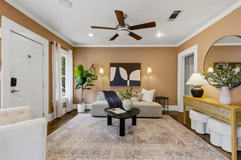 a living room with furniture and a chandelier