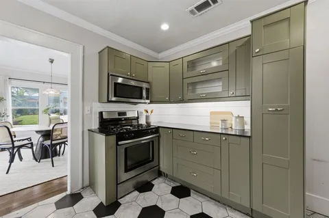 a kitchen with stainless steel appliances granite countertop a stove and a refrigerator