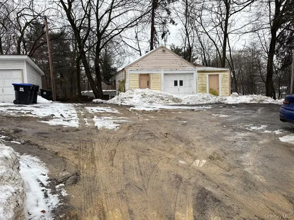 a front view of a house with a yard covered in snow