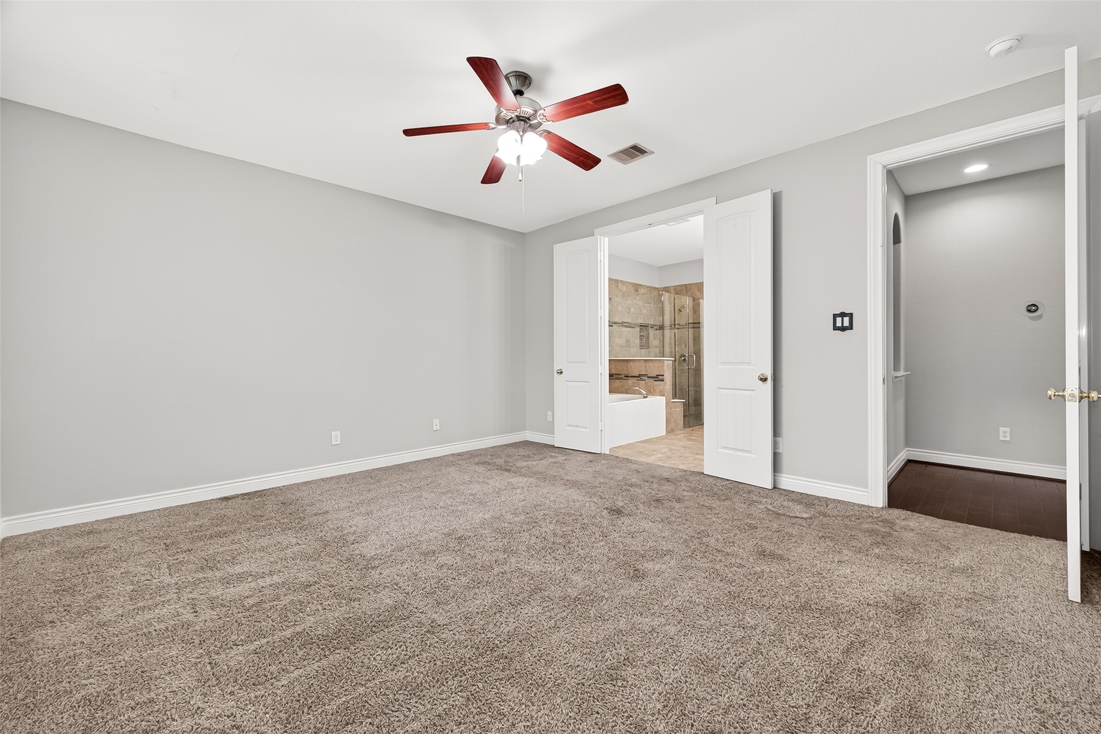 24122 Valencia Ridge Lane Katy, TX 77494 - Photo 33 of 46 Well-sized first-floor secondary bedroom located near a full bathroom, perfect for guests or multigenerational living.