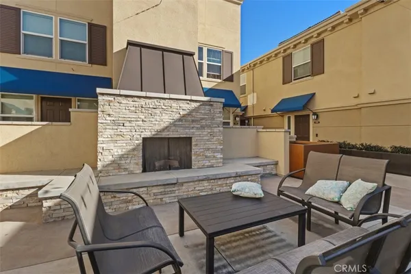 a backyard of a house with table and chairs