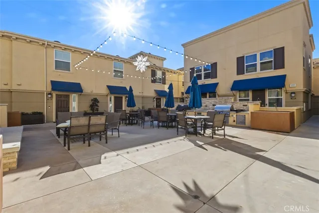 a view of a patio with dining table and chairs
