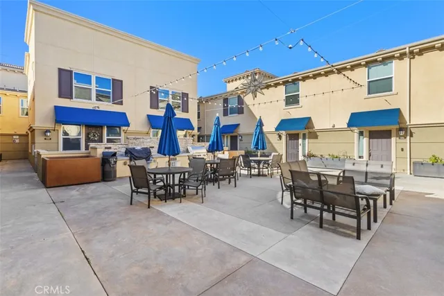 a view of a patio with a dining table and chairs