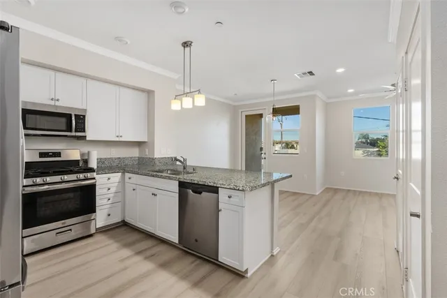 a kitchen with stainless steel appliances granite countertop a stove and a sink