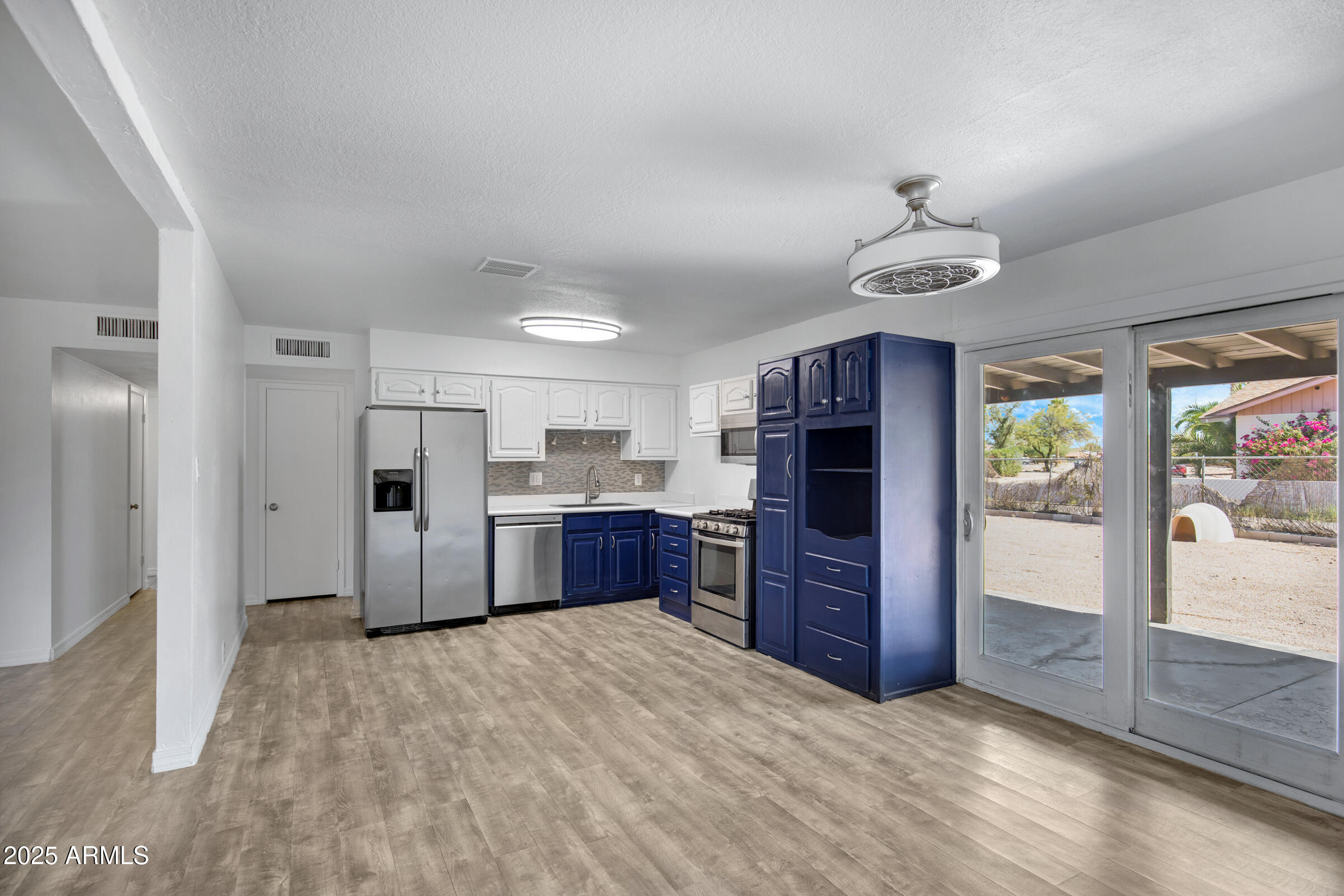 a kitchen with stainless steel appliances kitchen island granite countertop a refrigerator and a stove top oven