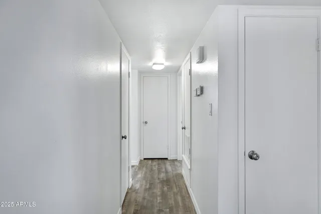 a view of a hallway with wooden floor