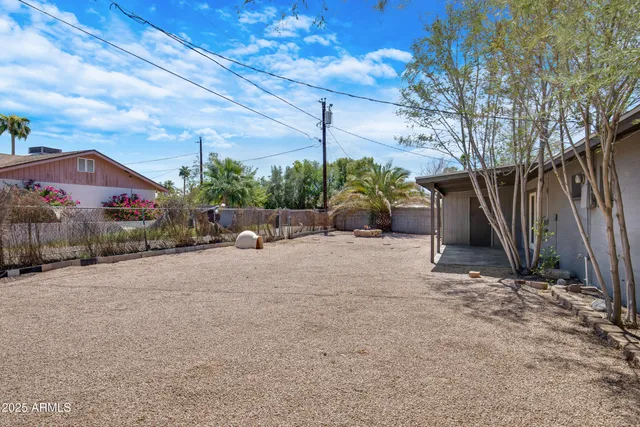 a view of a house with a yard and tree s
